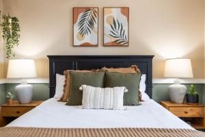 a bedroom with a large bed with two lamps at Gilbert Beachcomber in Gilbert +56 photos