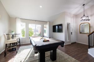 a living room with a pool table and a tv at Gilbert Comstock in Gilbert