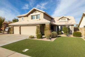 a house with a yard of green grass at Gilbert Comstock in Gilbert
