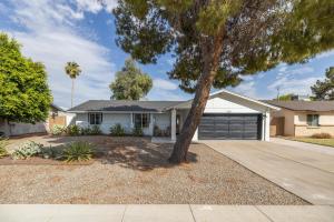 a white house with a tree in the driveway at Gilbert East Laurel in Gilbert