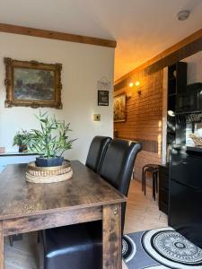 a dining room with a table and black leather chairs at Studio A - Newly renovated 2 bed studio in Nottingham