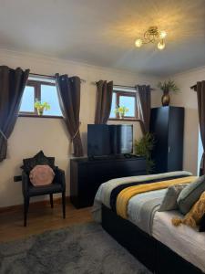 a bedroom with a bed and a flat screen tv at Studio A - Newly renovated 2 bed studio in Nottingham