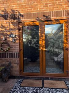 a glass door on a brick building with a patio at Studio A - Newly renovated 2 bed studio in Nottingham