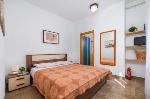a bedroom with a bed and a mirror in it at Garden House Premantura in Premantura