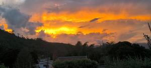 an orange and yellow sky with clouds in the sky at Hotel Casa de Teja in Norcasia +7 photos