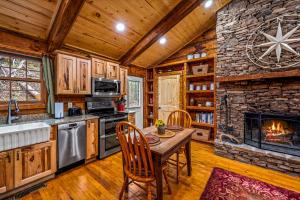 a kitchen with a table and a stone fireplace at Wildwood in Townsend