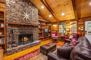 a living room with a large stone fireplace at Wildwood in Townsend