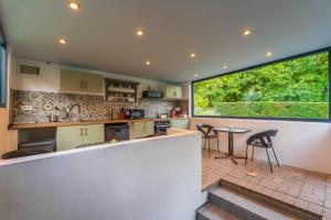 a kitchen with a counter and a table and chairs at Villa Szent Jakab in Vászoly +65 photos