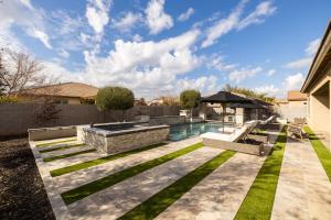 a backyard with a swimming pool and grass at Queen Creek on 193rd in Queen Creek