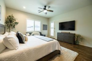 a bedroom with a bed and a flat screen tv at Queen Creek on 193rd in Queen Creek