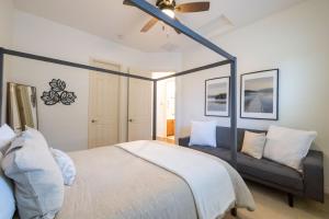 a bedroom with a bed and a couch at Queen Creek on 193rd in Queen Creek +40 photos