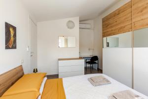 a small bedroom with a bed and a desk at Dimora Sant Anna in Piacenza