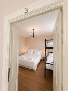 a bedroom with two beds and a bunk bed at Casa Andra in Drobeta-Turnu Severin