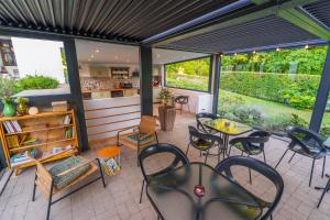 a patio with tables and chairs and a kitchen at Villa Szent Jakab in Vászoly