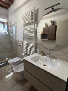 a bathroom with a sink and a toilet and a mirror at Casetta di pisolo in Pistoia +7 photos