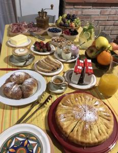 a table topped with plates of food and fruit at Bed and Breakfast Family Palazzo Stillitano Stilo in Stilo +22 photos