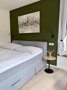 a bedroom with a bed and a side table at FEWO Studio7 in Vorderelsenwang
