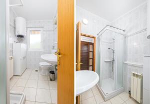 a bathroom with a toilet sink and a shower at Garden House Premantura in Premantura +19 photos