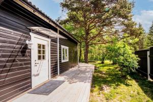 a wooden ramp leading to a building with a white door at 'Ekhaga Cabins' Lillestugan in Viddviken