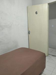 a room with a door with the number on it at Pousada Bom Jesuss in Juazeiro do Norte