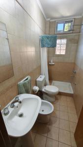 a bathroom with a sink and a toilet and a shower at Alojamiento Tía Silvia in San José +20 photos