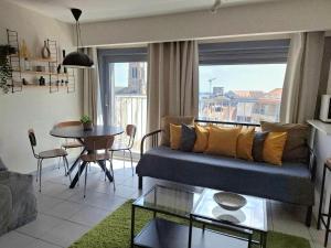 a living room with a couch and a table at BC Studios in Blankenberge +32 photos
