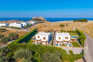 an aerial view of a house and the ocean at Lindos Emerald in Lindos