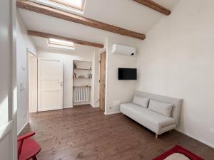 a living room with a couch and a tv at Ancona design apartment in Ancona
