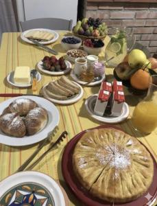 a table topped with plates of food and fruit at Bed and Breakfast Family Palazzo Stillitano Stilo in Stilo