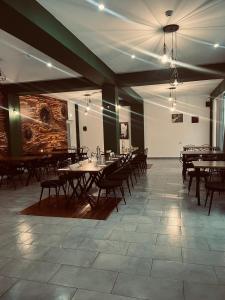 a dining room with tables and chairs in a building at Paunasul Codrilor in Câmpulung Moldovenesc +50 photos