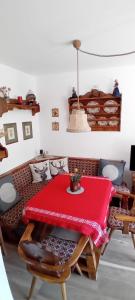 a room with a table with a red table cloth at La Sibilla in Riscone