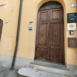 a large wooden door on the side of a building at Tuscan Sunsets Tramonti Toscani in Fauglia
