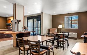 a restaurant with tables and chairs and a kitchen at My Place Hotel-Missoula, MT in Missoula