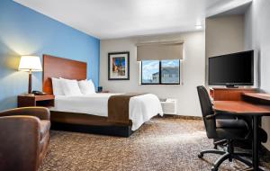 a hotel room with a bed and a flat screen tv at My Place Hotel-Missoula, MT in Missoula