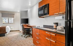 a kitchen with a desk and a computer in a room at My Place Hotel-Missoula, MT in Missoula +16 photos