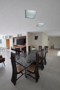 a dining room with a table and chairs at DunnaAP Smart Studios in Catalão