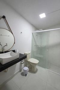 a bathroom with a toilet and a sink and a shower at DunnaAP Smart Studios in Catalão