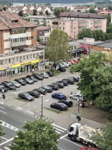 a city street with cars parked in a parking lot at Ioana Home in Râmnicu Vâlcea