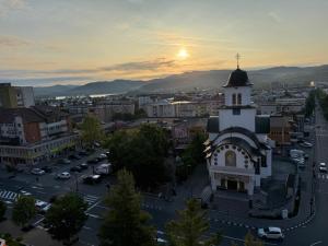 a view of a city with a clock tower at Ioana Home in Râmnicu Vâlcea +8 photos