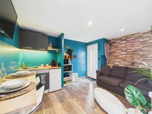 a living room with a couch and a table at L'instant secret in Berlaimont