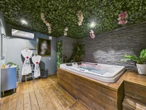 a jacuzzi tub in a room with a brick wall at L'instant secret in Berlaimont +11 photos