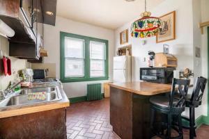 a kitchen with a sink and a counter top at Cozy Cape Cod Bungalow King Queen WD Full Kitchen Wifi Desk in York +6 photos