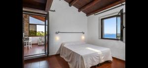 a bedroom with a bed with a view of the ocean at Seafront wow appartamento Baja Sardinia in Baja Sardinia