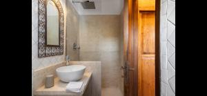 a bathroom with a sink and a mirror at Seafront wow appartamento Baja Sardinia in Baja Sardinia