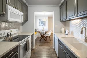 a kitchen with gray cabinets and a sink and a table at Scottsdale Camelback in Scottsdale