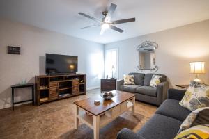 a living room with a couch and a tv at Scottsdale Miller in Scottsdale