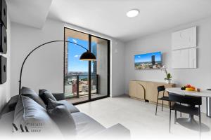 a living room with a couch and a table at Walking Distance from Bayside Market Place - 501 First Residences Junior Studio Rooftop Pool in Miami