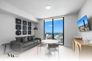 a living room with a couch and a table at Walking Distance from Bayside Market Place - 501 First Residences Junior Studio Rooftop Pool in Miami