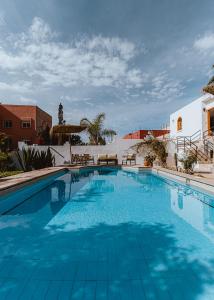 a large swimming pool with blue water at Riad TAWALA Surfing Mind in Tamraght Ouzdar