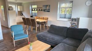 a living room with a couch and a table at Bauernhof Claussen Fehmarn in Fehmarn